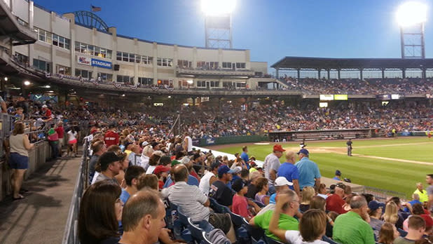 Fans at a baseball stadium watching a game.