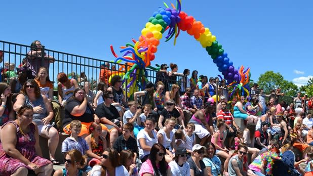 A crowd of people sitting in the stands at CNY Pride