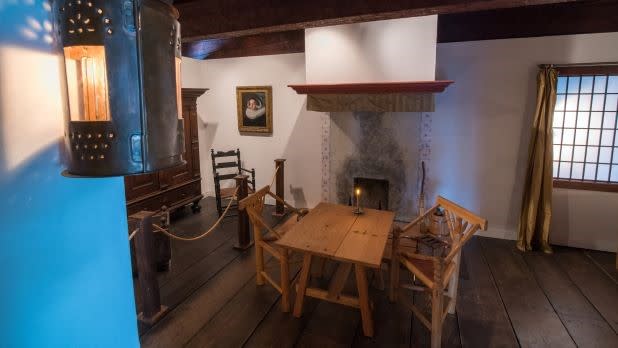 interior of a historic room with replica furniture and items