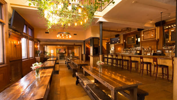 Wooden tables and chairs line the interior of The City Beer Hall