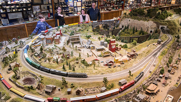 A family admires a 200-foot-long model train layout  at the Medina Railroad Museum.