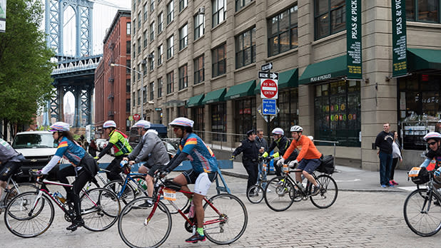 Cyclists in Brooklyn with a view of the Manhattan bridge behind them.