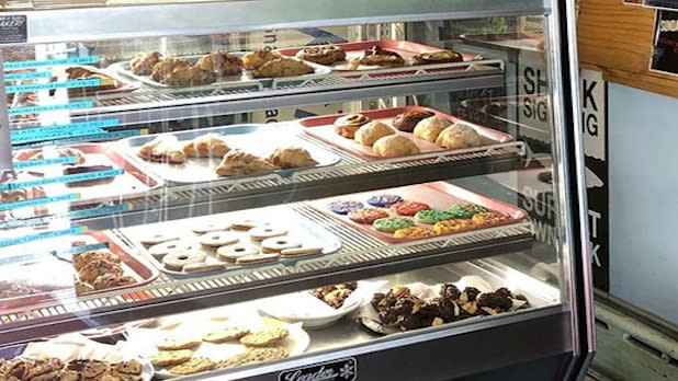 A deli case filled with cookies and pastries