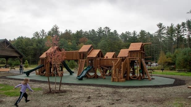 A child runs toward the playground at Frontier Town