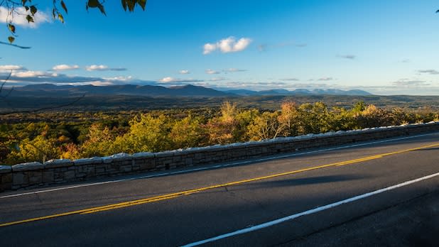 View along the Route 44/55 of the Shawangunk Mountains Scenic Byway of foliage across the Hudson Valley and the Catskill Mountains in the distance from above.