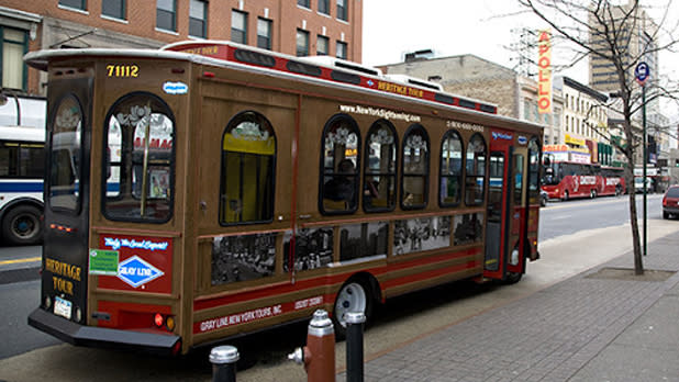 Exterior of a red and gold trolley parked on the street