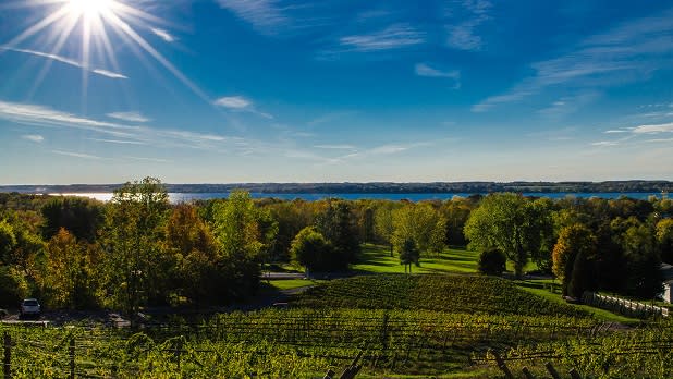 A bright sun shines over Cayuga Lake and the Heart and Hands Winery