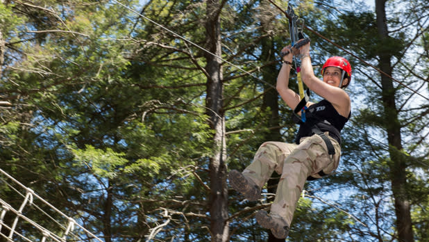 A person soars through the trees on the Hunter Mountain zipline