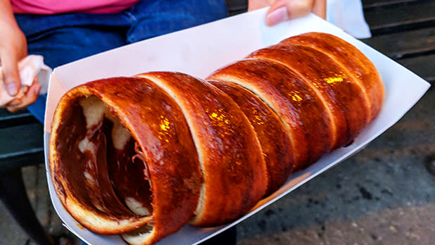 Rolled up dough of a Chimney Cake in a white take-away tray at a carnival