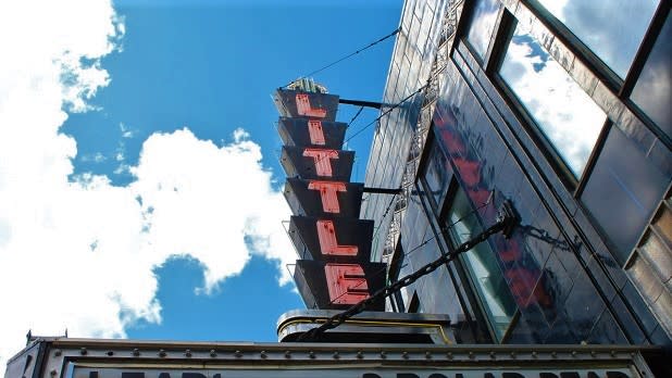 Red neon sign outside the Little Theatre