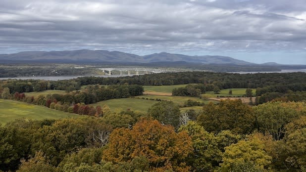 View of the Kingston-Rhinecliff Bridge, Hudson River, and surrounding Catskill Mountains from the top of the Ferncliff Forest Fire Tower in Rhinebeck, NY in early fall.