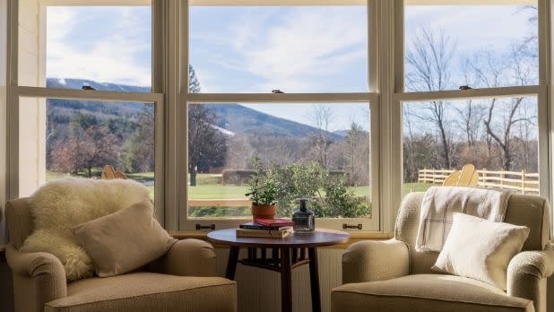 Interior room of the Wylder Windham resort with views of Windham mountain through the windows