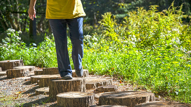 A child walking along the log stump steps at Letchworth Autism Nature Trail