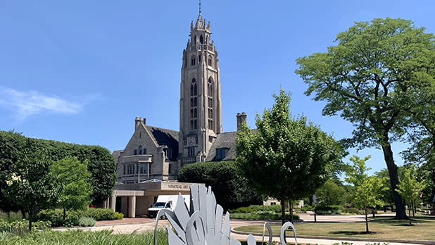 The main building and tower of the Memorial Art Gallery set against a blue sky