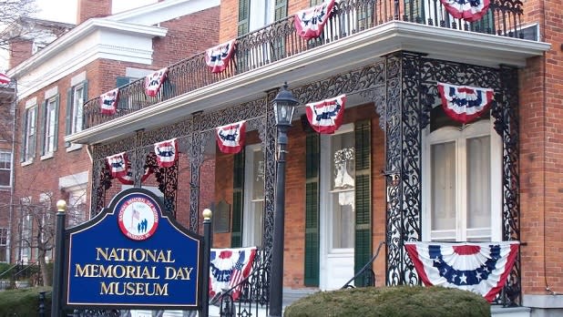 The exterior of the red brick and blue sign of the National Memorial Day