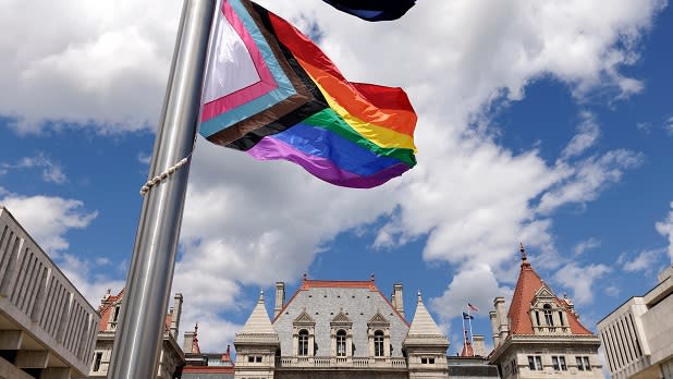 Progressive Pride Flag flies outside the Capitol Building at Empire State Plaza