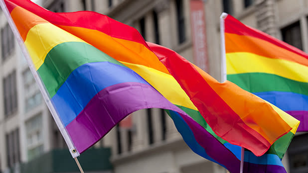 Two rainbow flags billowing in the wind in NYC