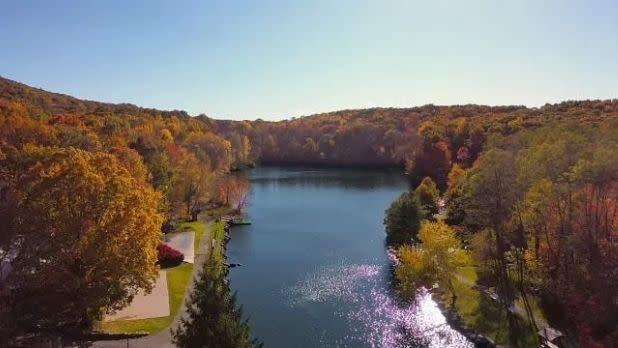 A view of the lake at Rocking Horse Ranch surrounded by fall foliage