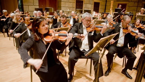 The Rochester Philharmonic Orchestra strings section playing in a show