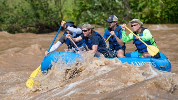 A group paddles down the Delaware River on a whitewater rafting adventure with Lander's River Trips