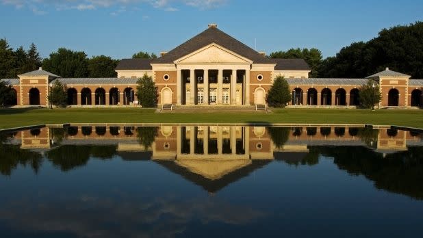 The facade of Roosevelt Baths & Spa in front of a manmade lake