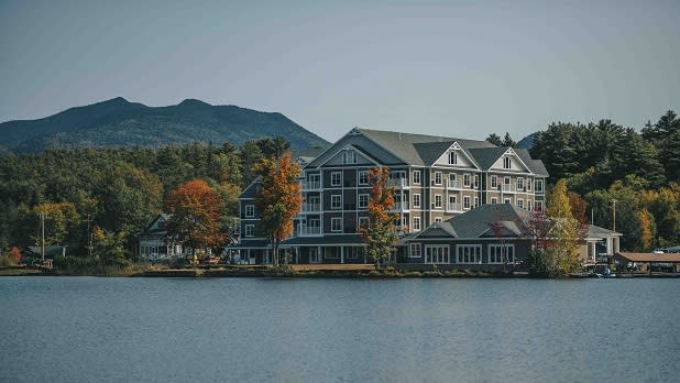 Saranac Waterfront Lodge overlooking the lake with mountains in the background