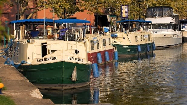 Erie Canal Cruise Lines houseboats docked near Seneca Lake in Seneca Falls
