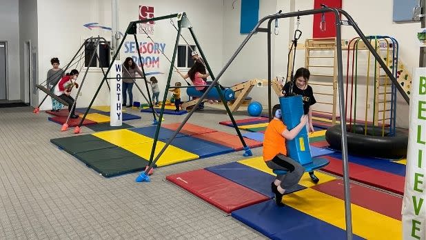Children playing in a multicolored sensory gym at Bring on the Spectrum