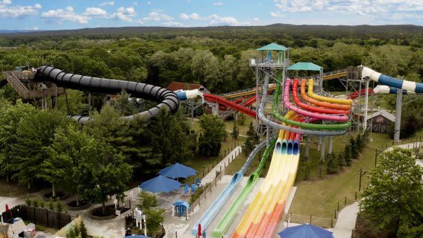 aerial view of brightly-colored waterslides surrounded by green trees