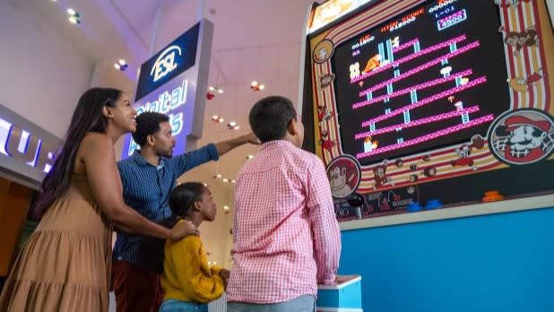 a family of four plays the world's largest playable Donkey Kong arcade game