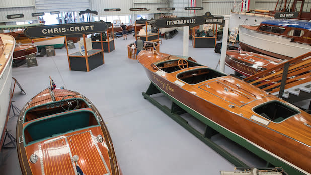 Interior of the Antique Boat Museum filled with a shiny wood boats