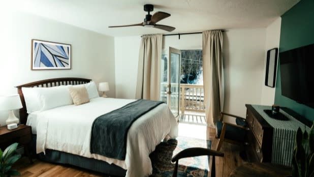 Interior of a modern bedroom with a balcony view at The Perch Hotel on a Catskills getaway