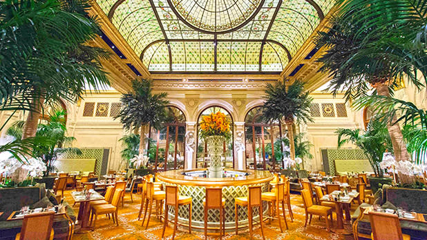 Interior courtyard bar at The Plaza underneath a glass rooftop