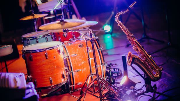 a set of drums and a saxophone on stage