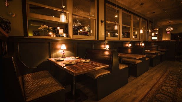 Dimly lit restaurant with a line of booth tables