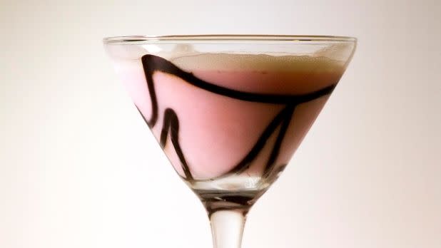 A pink martini with chocolate swirls