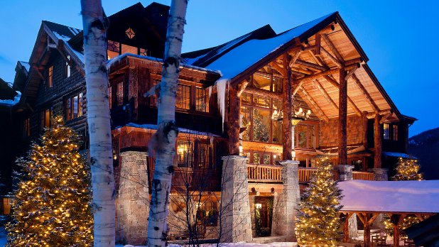 The exterior of the Whiteface Lodge illuminated at night in winter