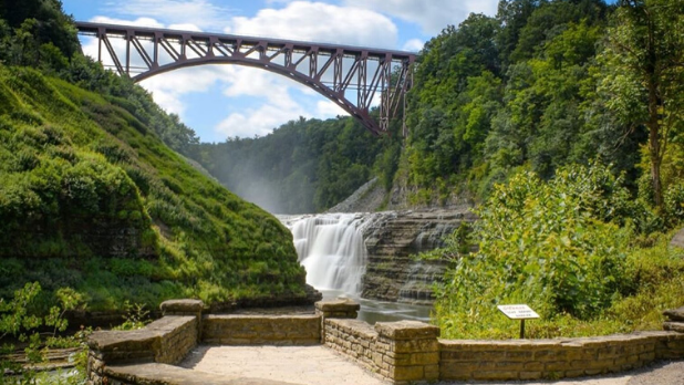 A photo of the Letchworth State Park during the summer with cascading waterways and green foliage