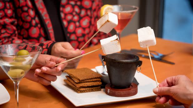 homemade smores being roasted at a table