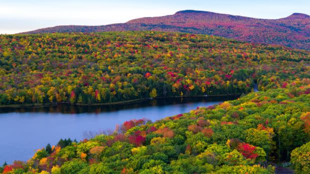 Blue lake surrounded by colorful foliage and mountains