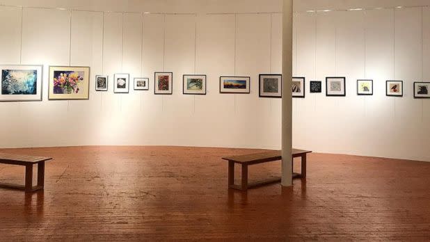 inside showroom of arts center, photos on wall