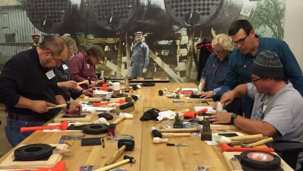 Group of people doing metalworking