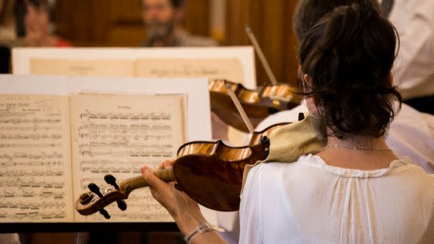 Close-up shot of violinist reading sheet music