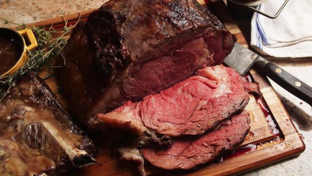 Prime rib sliced on a cutting board