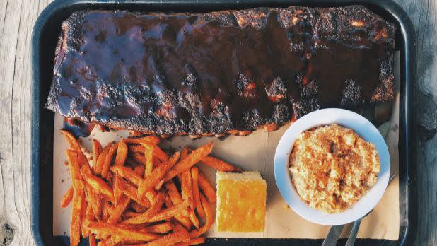 Tray of BBQ ribs, sweet potato fries, corn bread