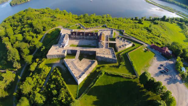 Aerial photo of Fort Ticonderoga surrounded by lush greenery and a great lake