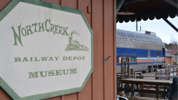 Railway Depot sign in front of a railway car