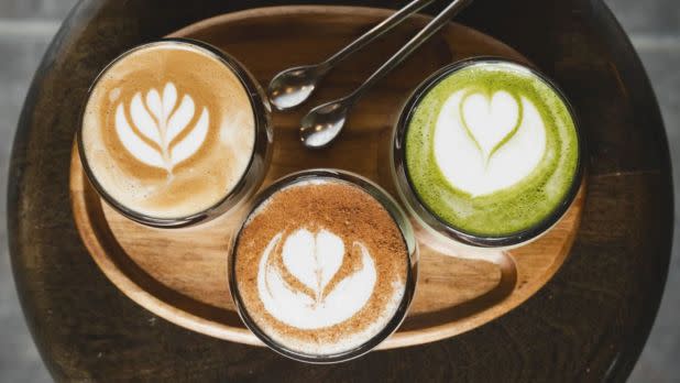 Three specialty coffee drinks in glasses with latte art