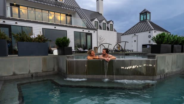 A couple in a hot tub at the Inns of Aurora