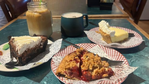 A table with three different slices of pie and an iced coffee drink